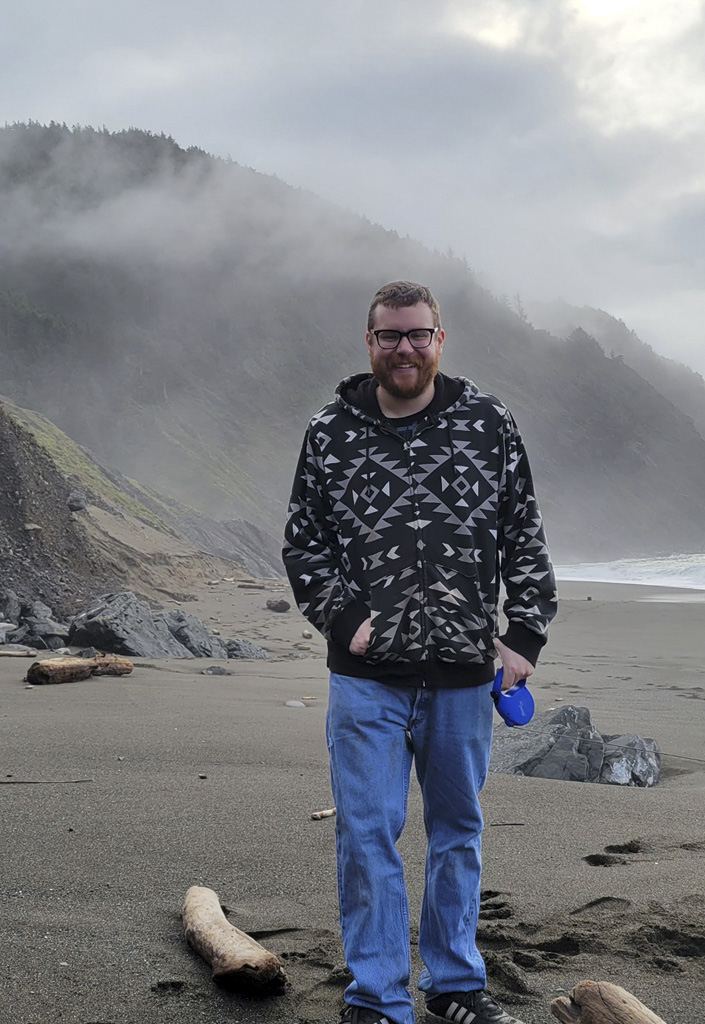 Jayce Nusser standing on a misty beach.